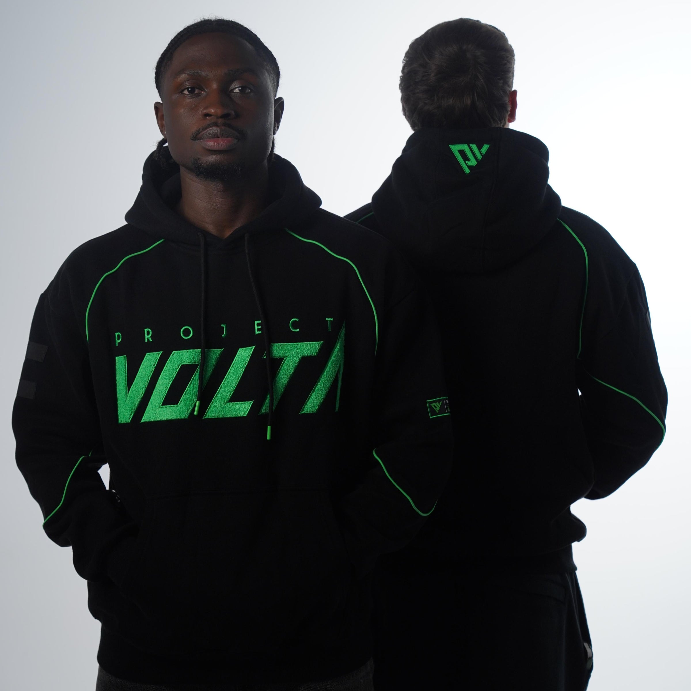 Two people wearing Project Volta Hoodies with green text on a white background
