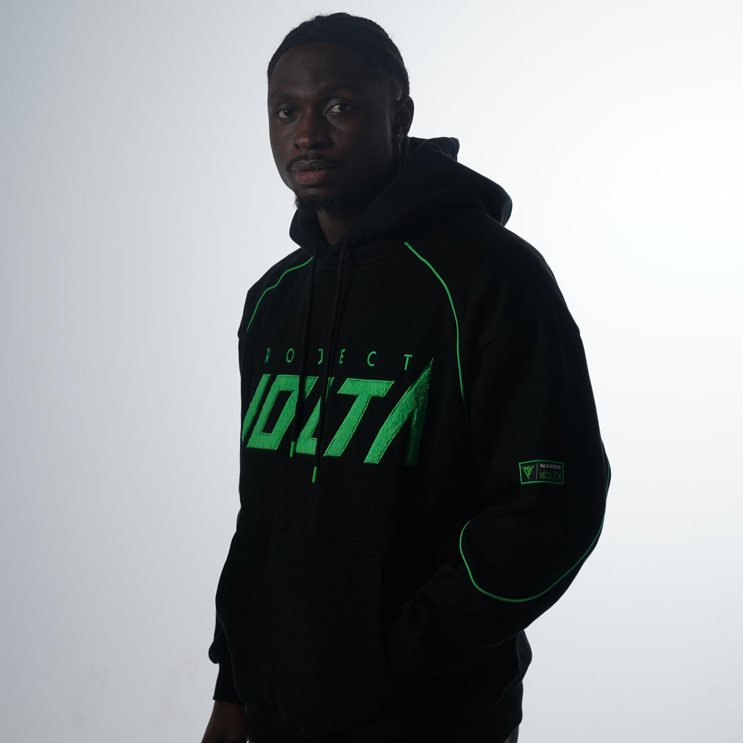 Person wearing a black hoodie with green text on a white background