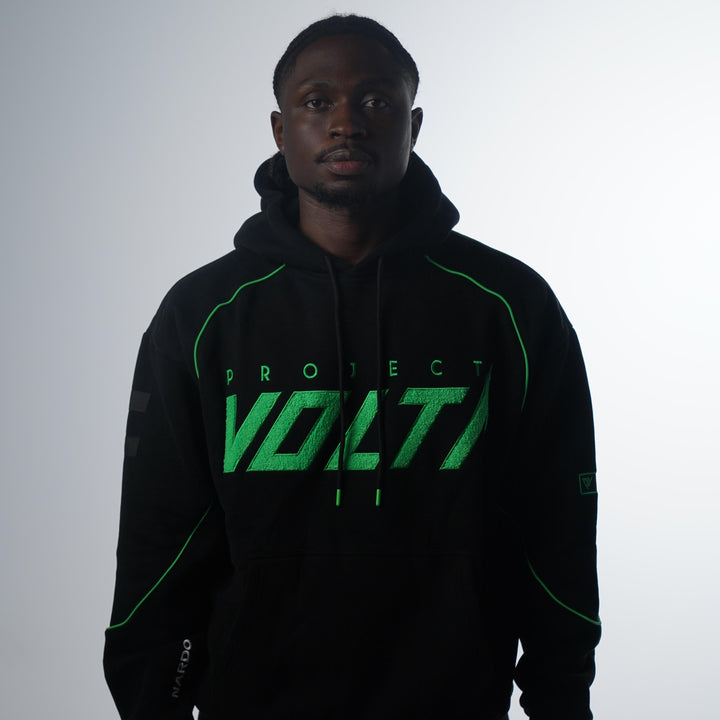 Person wearing a black hoodie with green text on a white background